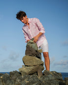 Men’s pink Agave print linen shirt by Pink House Mustique, relaxed island style with white shorts.