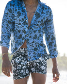 Men’s Iguana print linen shirt in blue spruce with dark spruce swim shorts by Pink House Mustique, beachwear look.