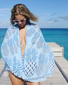 Hand-printed Lotty B silk sarong in Blue Pineapple design, sustainable tropical resortwear shot on Cotton House pier, Mustique.