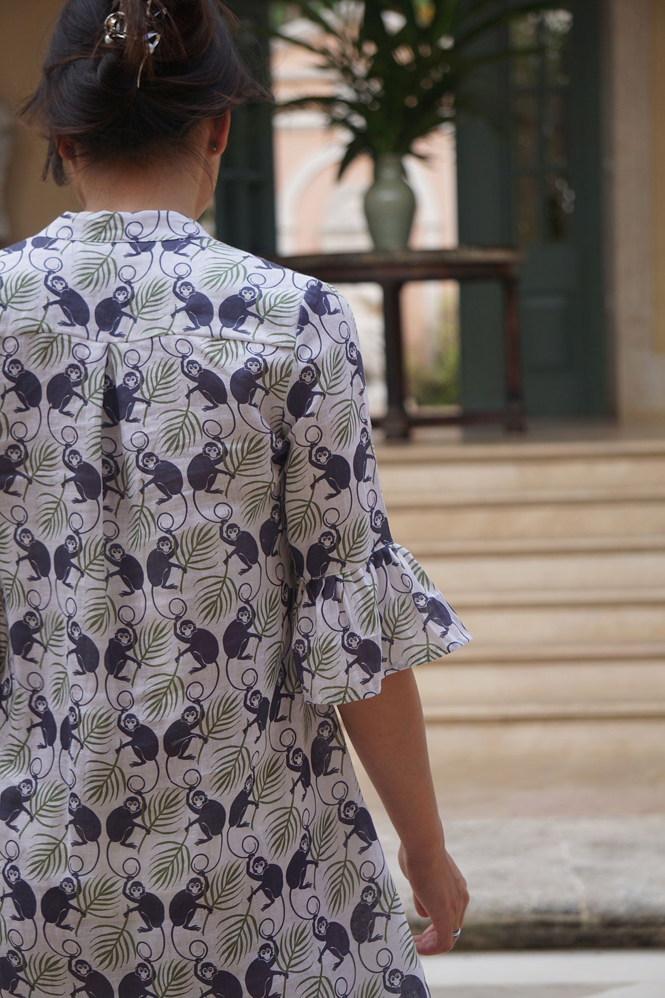 Women's easy travel linen dress in green and navy Monkey print styled at a villa on Mustique Island by Pink House