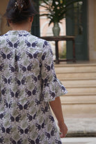Women's easy travel linen dress in green and navy Monkey print styled at a villa on Mustique Island by Pink House
