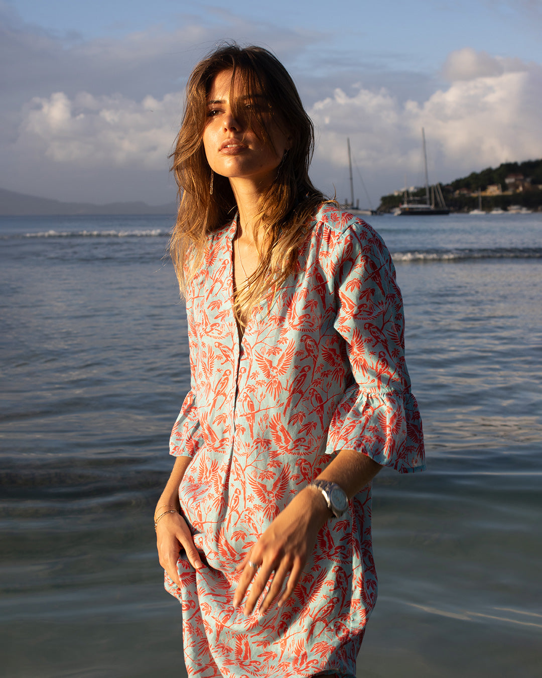 Close-up of Pink House Linen Decima Dress in Parrot Coral/Turquoise – stylish women's beach dress with tropical parrot print, perfect for vacation or summer getaways.