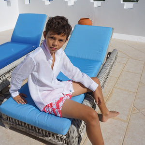Childrens Linen Shirt: WHITE sitting on a sunbed Mustique