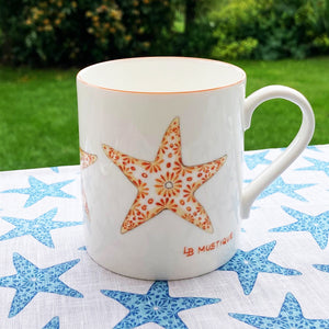 Fine bone china mug and linen seastar tablecloth designed by Lotty B for Pink House Mustique