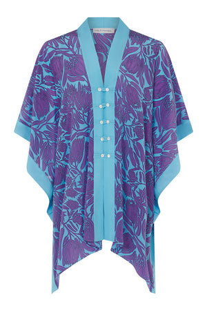 Silk buttoned poncho cape in violet & turquoise Protea print designed by Lotty B Mustique