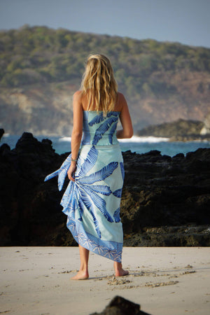 Large pure silk sarong scarf in Banana Tree blue design by Lotty B Mustique styled with matching stretch silk bandeau top
