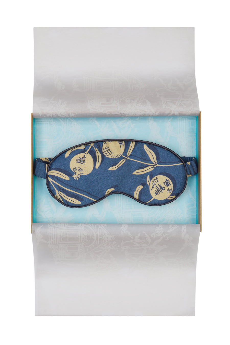 Luxury silk eye mask in gold and navy Pomegranate print. Limited edition sleepwear accessories by Lotty B Mustique. Handmade in England
