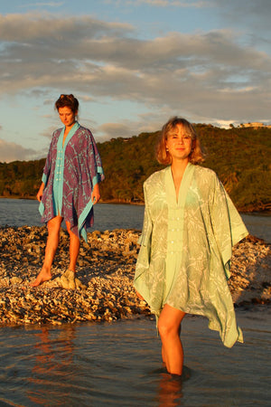 Tropical vacation style buttoned poncho in floral green Protea print by Lotty B Mustique