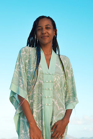 Chic vacation style buttoned poncho in floral green Protea print by Lotty B Mustique