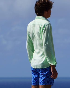 Mens holiday shirt solid green worn with blue swim shorts in pomegranate print by designer Lotty B for Pink House Mustique 