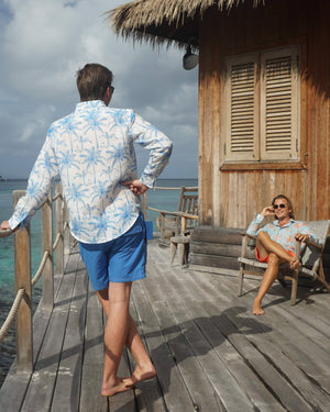 Colourful linen shirts tropical palm print in white and blue by Lotty B Mustique