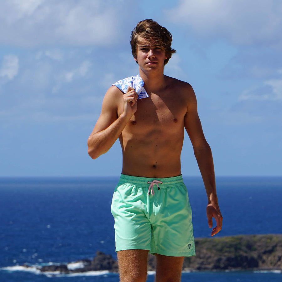Mens quick-dry swim shorts in solid green designer Lotty B Mustique for Pink House holiday essentials