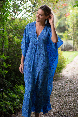 Maxi length flowy silk kaftan dress, blue flamboyant flower print by luxury resort wear designer Lotty b Mustique